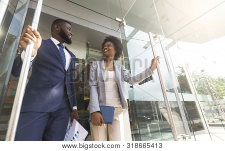 Happy Confident African American Business People Walking Out Of Modern Office Center After Successfu