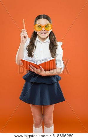 Happy Little Schoolgirl Ready For Lesson. Cute Child With Book. Only Wisdom Knowing You Know Nothing