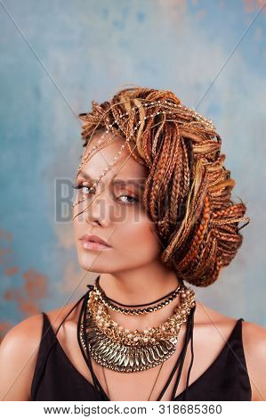 Southern Flavor. Portrait Of A Luxurious Tanned Woman, Pensive, Stylish, With An Exotic Hairstyle An