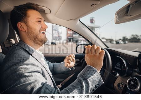 Happy Driver In A Suit Dancing In His Luxary Car Listening To Music And Enjouying Life. Concept Of S