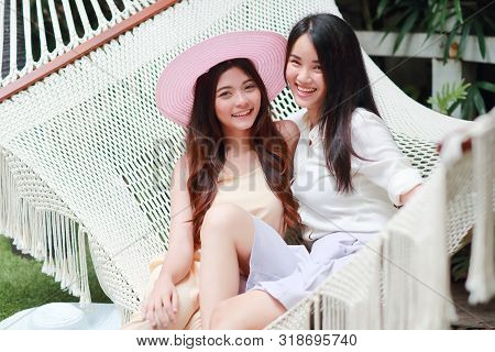 Young And Cute Asian Women With Hat Lying In A Hammock During Holiday