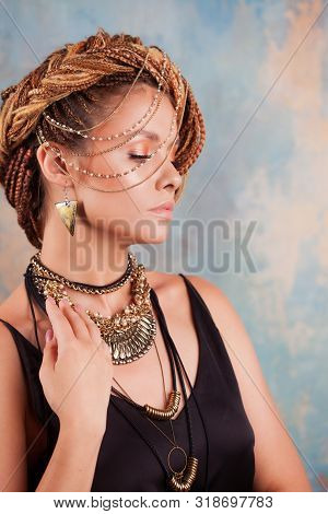 Southern Flavor. Portrait Of A Luxurious Tanned Woman, Pensive, Stylish, With An Exotic Hairstyle An