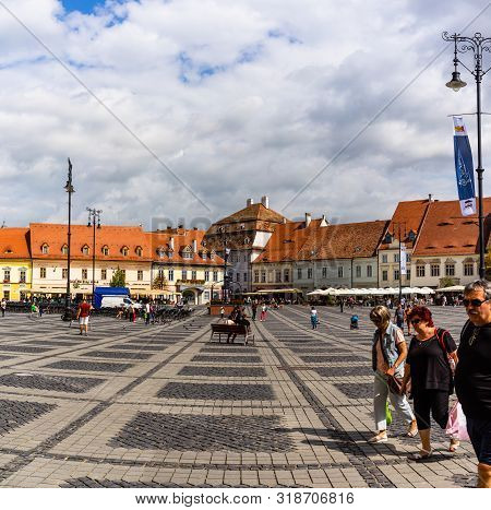 Sibiu, Romania - 2019. Tourist Wondering In The Panoramic The Big Square (piata Mare) Of Sibiu Looki