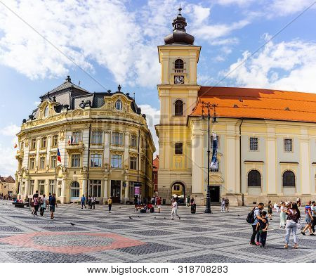 Sibiu, Romania - 2019. Tourist Wondering In The Panoramic The Big Square (piata Mare) Of Sibiu Looki