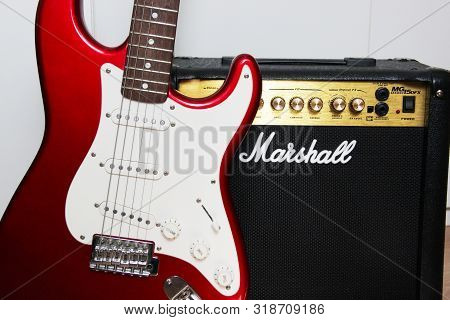 Moscow, Russia - March 11, 2018: Close Up Of A Marshall Guitar Amplifier And A Red Electric Guitar