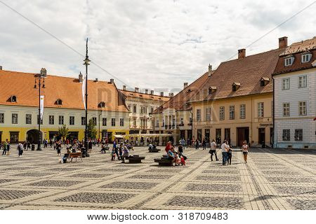 Sibiu, Romania - 2019. Tourist Wondering In The Panoramic The Big Square (piata Mare) Of Sibiu Looki