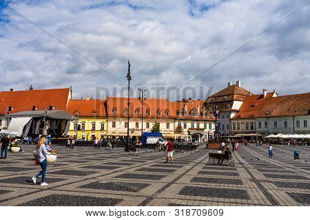 Sibiu, Romania - 2019. Tourist Wondering In The Panoramic The Big Square (piata Mare) Of Sibiu Looki