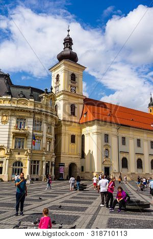 Sibiu, Romania - 2019. Tourists Wandering In The Big Square Of Sibiu (piata Mare).