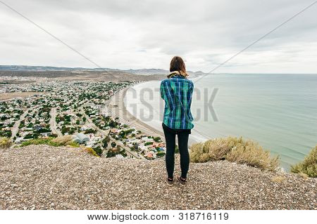 Girl Is Looking At Images Of The Region Of Comodoro In Argentina