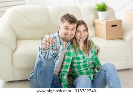 Young Married Couple With Boxes And Holding Flat Keys.