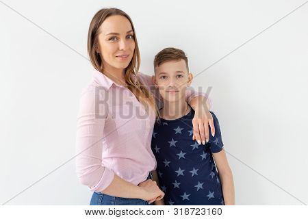 Good-looking Single-parent Mom And Teen Son On White Background. Cohesion, Friendship And Family Rel