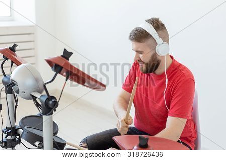 Music, Hobby And People Concept - Young Man Drummer Playing The Electronic Drums