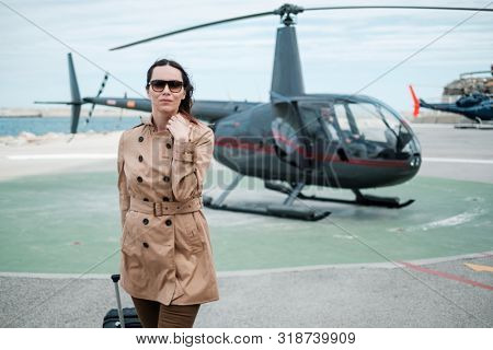 Business woman near private a helicopter