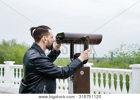 Modern Stylish Man Looking In Stationary Binoculars From The Observation Deck. Concept Of Tourism, T
