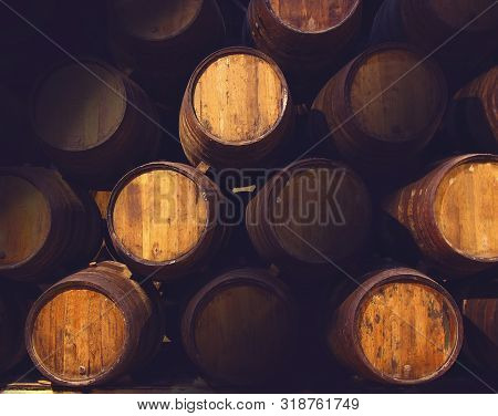 Row Of Wooden Barrels Of Tawny Portwine ( Port Wine ) In Cellar, Porto, Portugal. Vintage Old Style