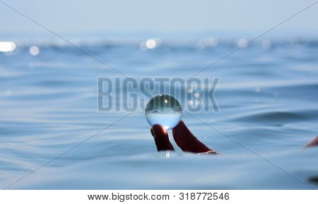 Beautiful Summer Coast Seen Through A Blue Glass Ball/ Blue Freedom Concept/ Ocean Surface Ripples A
