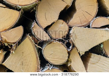 Natural Organic Wooden Cut Logs Background - Closeup Of Chopped Firewood. Firewood Stacked And Prepa