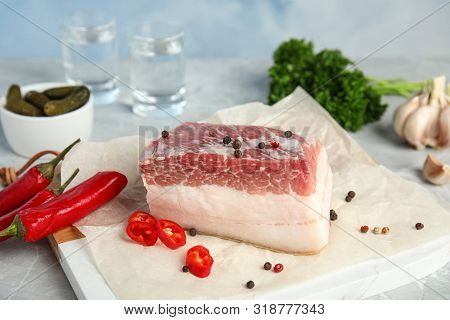 Composition With Pork Fatback And Spices On White Table Against Blue Background