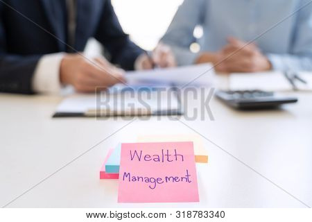 Wealth Management Concept, Business Man And Team Analyzing Financial Statement For Planning Financia