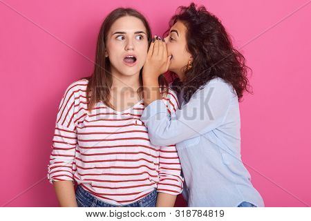 Two Young Attractive European Girls Wearing Casual Clothes Standing And Posing Isolated Over Pink Wa