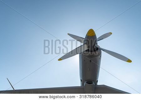 Airplane Propeller Of Military Aircraft, Copy Space. Blue Sky Background.