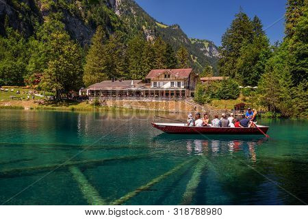 Blausee Lake, Switzerland - July 23, 2019 : Tourists Taking A Boat Trip On Blausee Lake Located In T