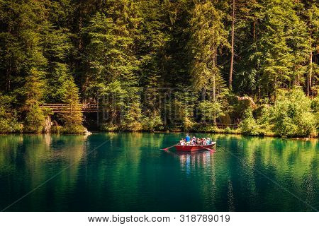 Blausee Lake, Switzerland - July 23, 2019 : Tourists Taking A Boat Trip On Blausee Lake Located In T