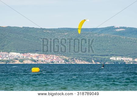 Sunny Beach, Bulgaria July 13, 2019. The Man Practices Hydrofoil Kitesurfing In The Black Sea Off Th