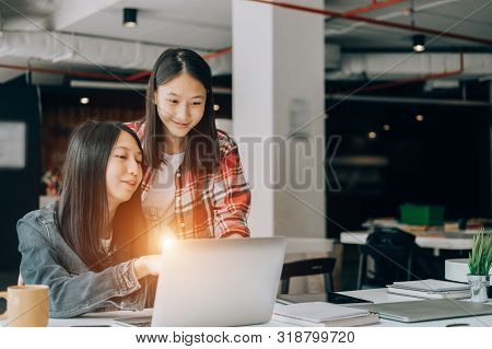 Young Studebt Sitting In Library College Studying And Sharing Knowledge With Laptop Together, Educat