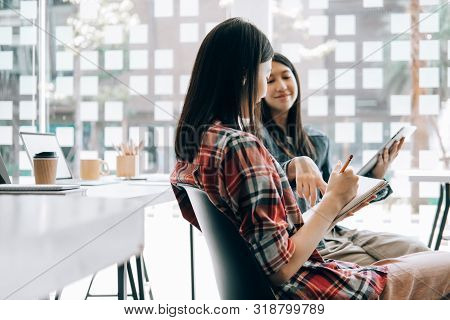 Young Studebt Sitting In Library College Studying And Sharing Knowledge With Laptop Together, Educat