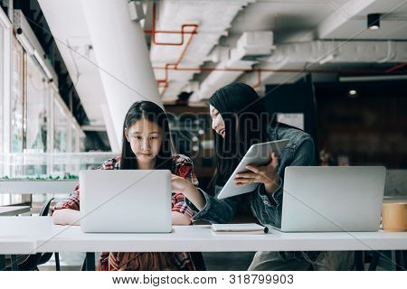 Young Studebt Sitting In Library College Studying And Sharing Knowledge With Laptop Together, Educat