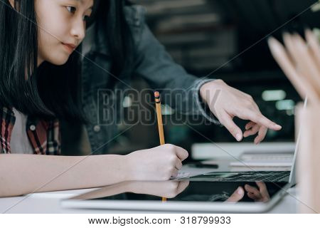 Young Studebt Sitting In Library College Studying And Sharing Knowledge With Laptop Together, Educat