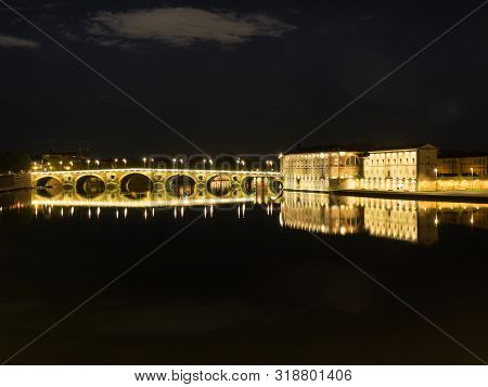 Night View Of The Toulousse Bridge Over The Garonne River With Reflection Of The Lights In The Water