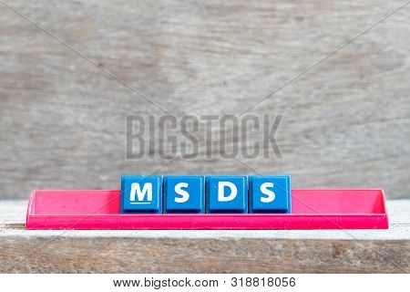 Tile Letter On Red Rack In Word Msds (abbreviation Of Material Safety Data Sheet) On Wood Background