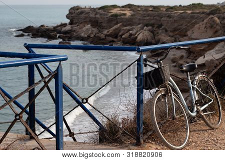 Old Vintage Bike Parked Over A Stunning Cliff In The Coast