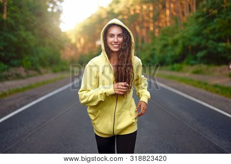 Close Up Portrait Curly Caucasian Young Girl Athlete Runs Sunny Summer Day On Asphalt Road In Pine F