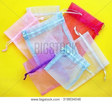 Organza Bags On Yellow Background. Organza Bags Can Be Used For Storage Different Things For A Long 