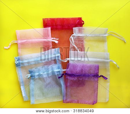 Organza Bags On Yellow Background. Organza Bags Can Be Used For Storage Different Things For A Long 