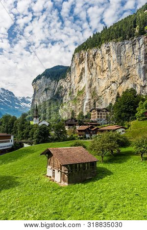 Amazing View Of Famous Lauterbrunnen Town In Swiss Alps Valley With Beautiful Staubbach Waterfalls B