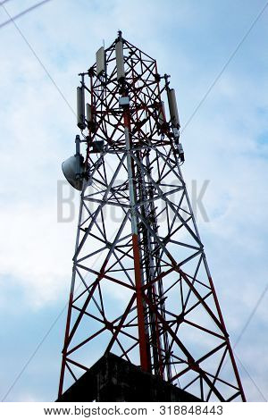 Cell Radio Phone Tower Standing Under The Nice Sky.