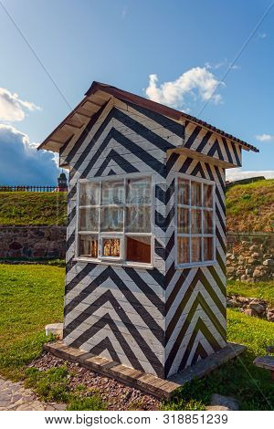 Striped Classic Watchtower For The Sentry In The Korela Fortress On A Summer Day Under A Blue Sky Ag