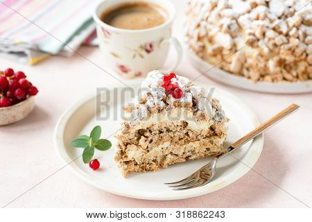 Hazelnut Daquoise Cake Or Kiev Cake With Meringue Layers And Vanilla Buttercream Served On White Pla