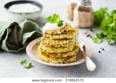 Vegetarian Zucchini Fritters Or Pancakes Stack Topped With Sour Cream And Cilantro. Vegetable Pancak