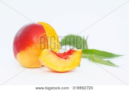 Delicious And Juicy Nectarina Peach With Leaves On White Background. Healthy Summer Fruit.