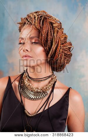 Southern Flavor. Portrait Of A Luxurious Tanned Woman, Pensive, Stylish, With An Exotic Hairstyle An