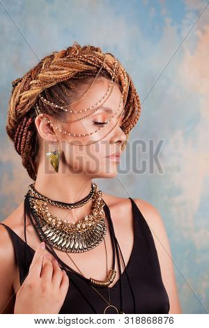 Southern Flavor. Portrait Of A Luxurious Tanned Woman, Pensive, Stylish, With An Exotic Hairstyle An