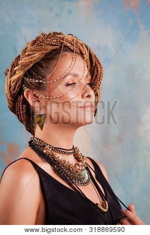 Southern Flavor. Portrait Of A Luxurious Tanned Woman, Pensive, Stylish, With An Exotic Hairstyle An