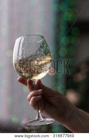 Hand Sommelier Holding Glass Of White Wine. Swirling Wine Glass In Wine Tastings  White Wine Concept