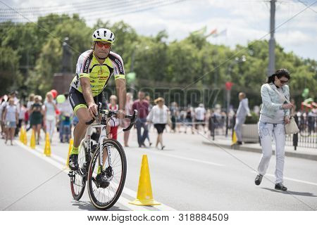 Belarus, The City Of Gimel, July 03, 2019. Youth Festival.a Cyclist In Bright Clothes Rides Through 
