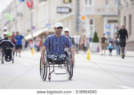 Belarus, The City Of Gimel, July 03, 2019. Youth Festival.wheelchair Race.a Man In A Wheelchair Comp